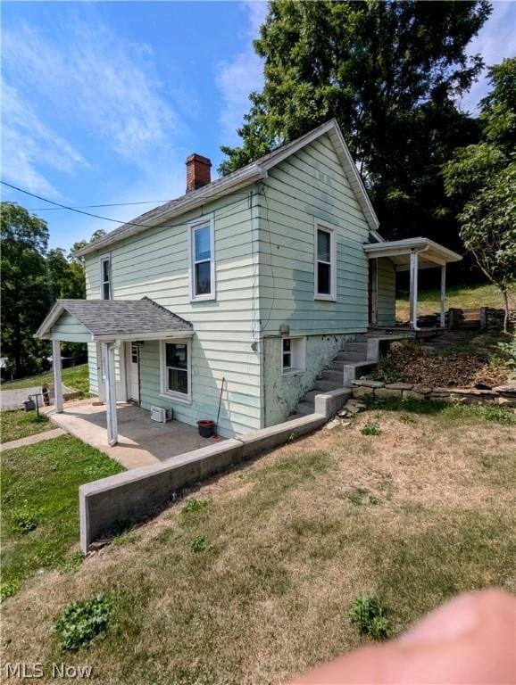 exterior space with a front lawn and covered porch