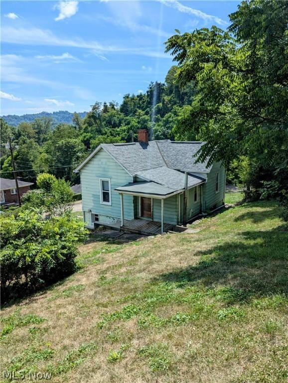 rear view of house featuring a yard