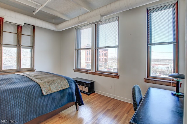 bedroom featuring multiple windows and wood-type flooring