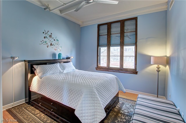 bedroom with crown molding, ceiling fan, and hardwood / wood-style floors