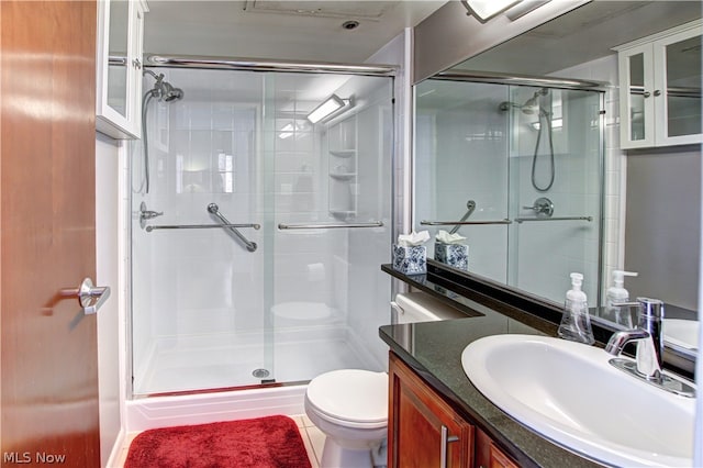 bathroom featuring vanity, toilet, tile patterned floors, and walk in shower