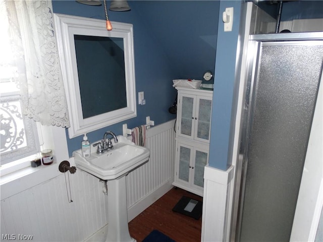 bathroom featuring wood-type flooring and an enclosed shower