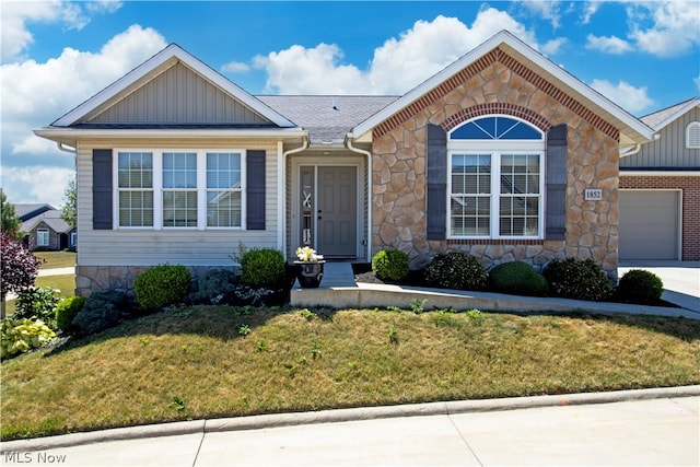 view of front of home featuring a garage and a front lawn