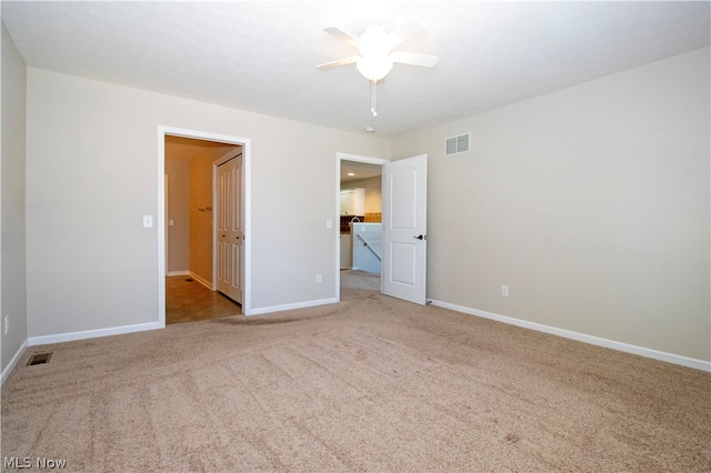 unfurnished bedroom featuring light carpet and ceiling fan