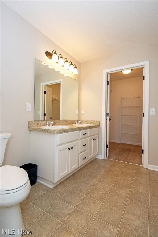 bathroom featuring tile patterned floors, vanity, and toilet