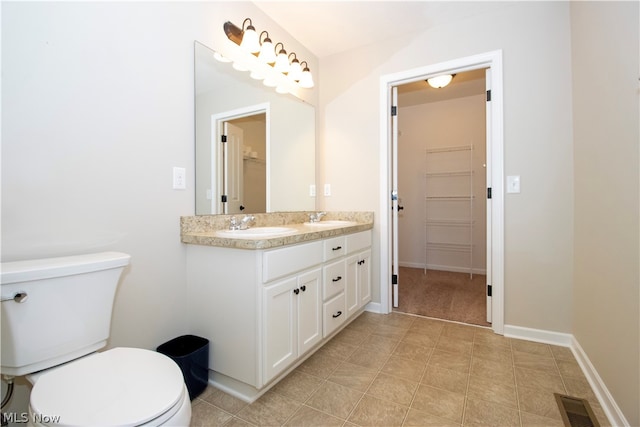 full bathroom featuring baseboards, visible vents, toilet, a spacious closet, and a sink