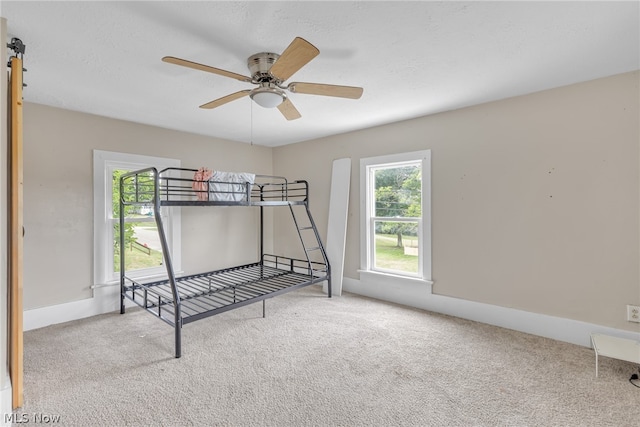 unfurnished bedroom featuring carpet floors and ceiling fan