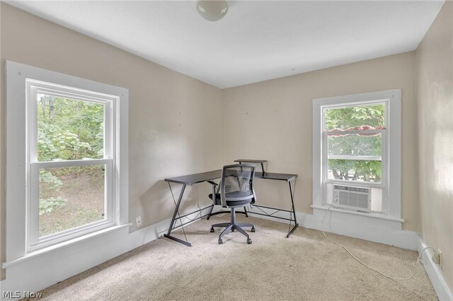 office area featuring light carpet, a healthy amount of sunlight, and cooling unit