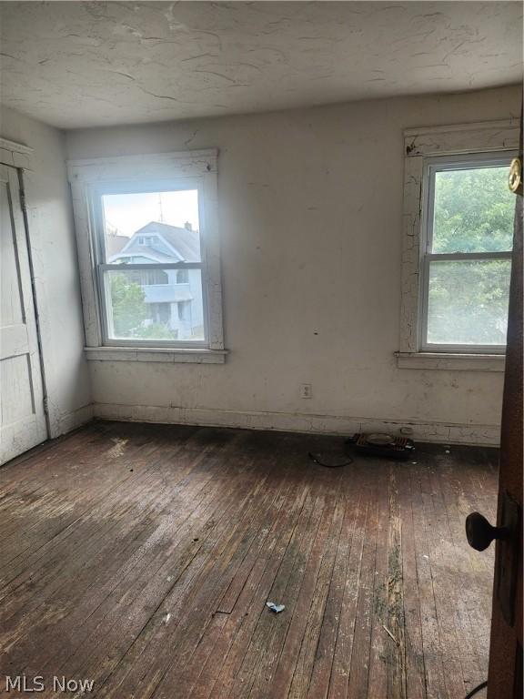 spare room featuring dark hardwood / wood-style flooring