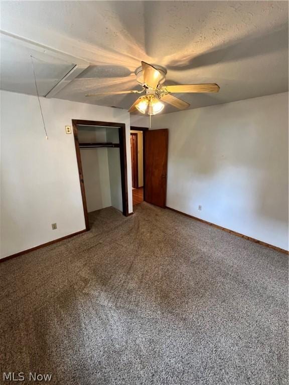 unfurnished bedroom with ceiling fan, carpet floors, and a textured ceiling