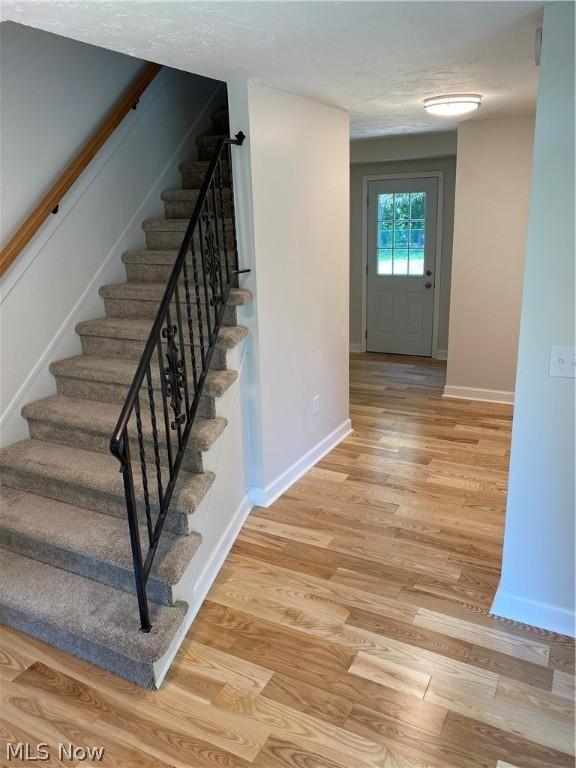 stairway featuring wood-type flooring