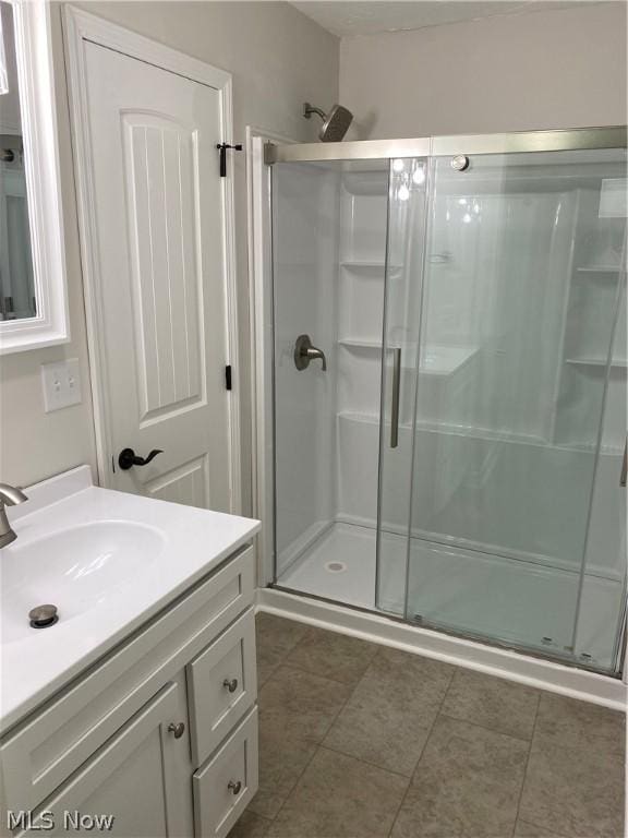 bathroom featuring vanity and an enclosed shower