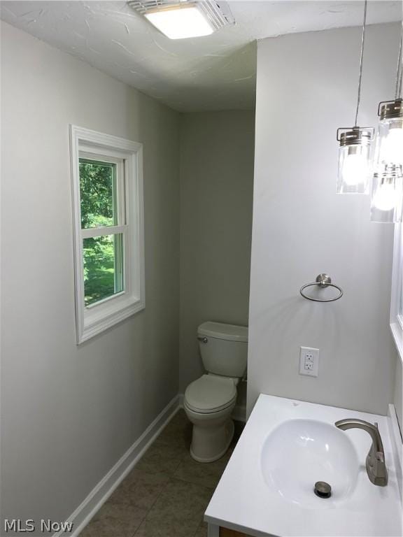 bathroom featuring tile patterned floors, vanity, and toilet