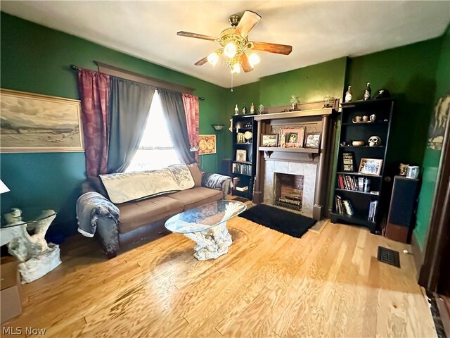 living room with hardwood / wood-style floors and ceiling fan