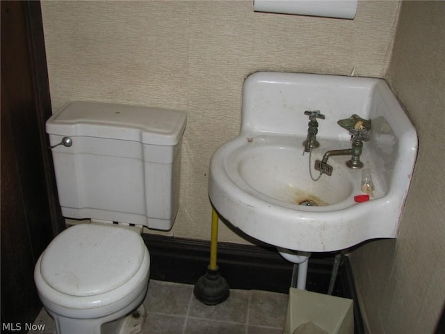 bathroom featuring tile patterned flooring and toilet