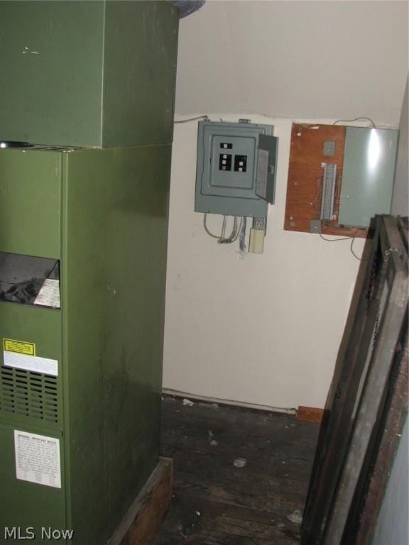 utility room with electric panel and heating unit