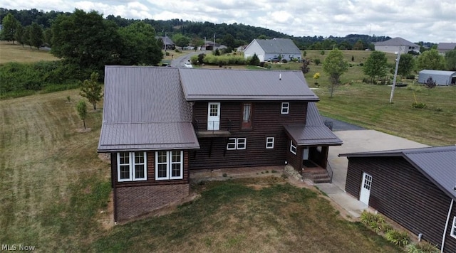 exterior space with a front lawn and metal roof