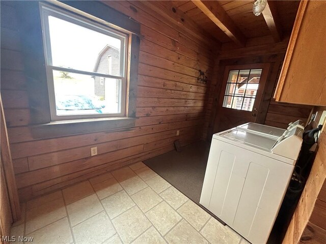 clothes washing area featuring cabinets, wooden walls, washer / dryer, and wooden ceiling