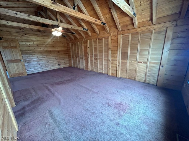 interior space with wood walls and vaulted ceiling