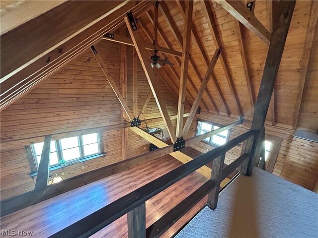 hallway featuring wood ceiling, wooden walls, beam ceiling, and high vaulted ceiling