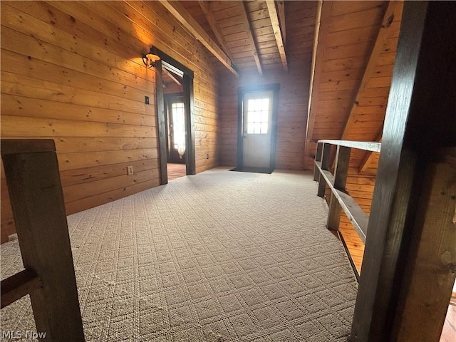 additional living space featuring carpet flooring, wooden ceiling, beam ceiling, and wood walls