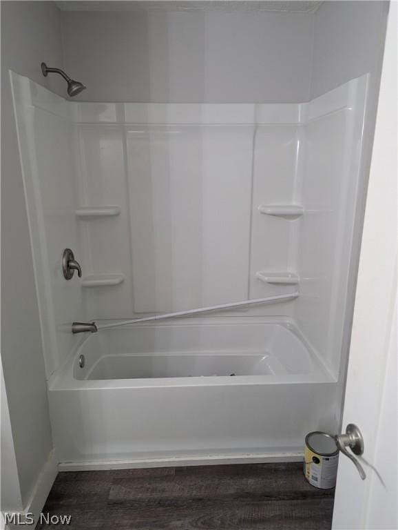 bathroom with shower / bathtub combination and hardwood / wood-style floors