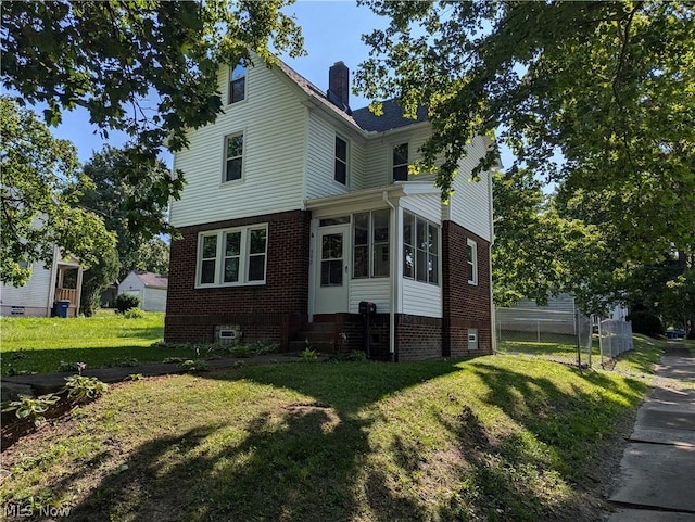 view of side of home with a lawn