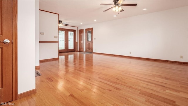 empty room featuring french doors, ceiling fan, and light hardwood / wood-style floors