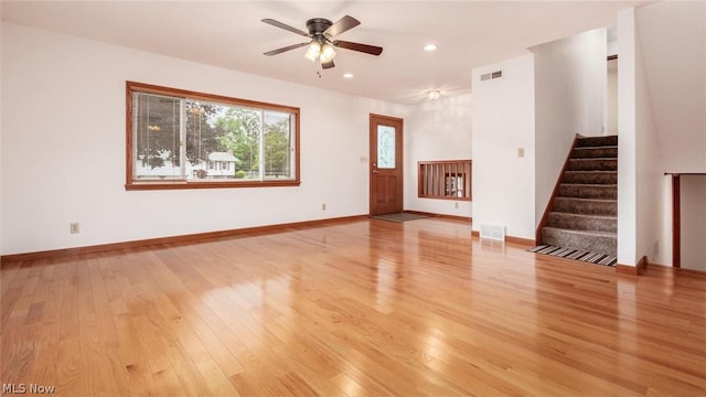 unfurnished living room with ceiling fan and light wood-type flooring