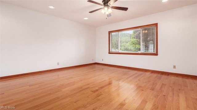 empty room featuring light hardwood / wood-style flooring and ceiling fan