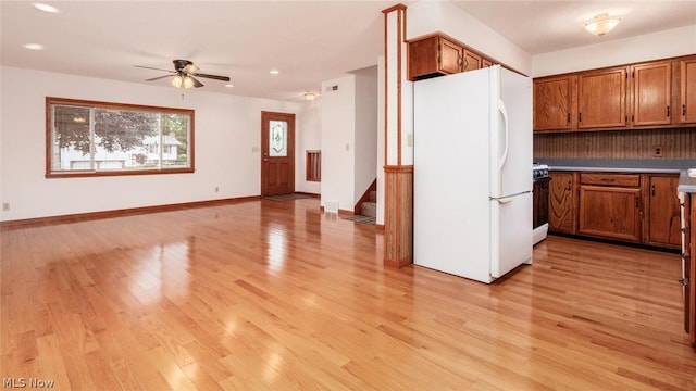 kitchen featuring ceiling fan, white fridge, and light hardwood / wood-style flooring