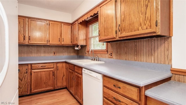 kitchen with white appliances, sink, and light wood-type flooring