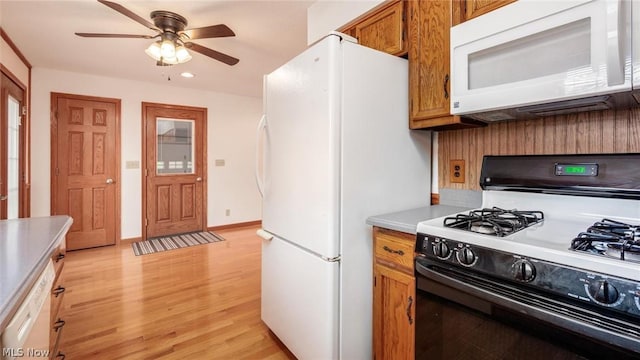 kitchen with white appliances, light hardwood / wood-style floors, and ceiling fan