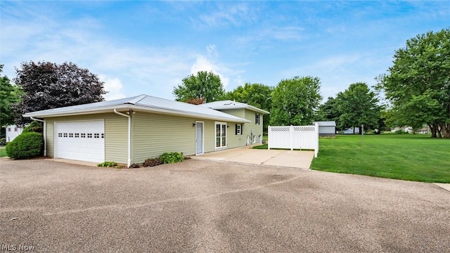 view of front facade with a garage and a front lawn