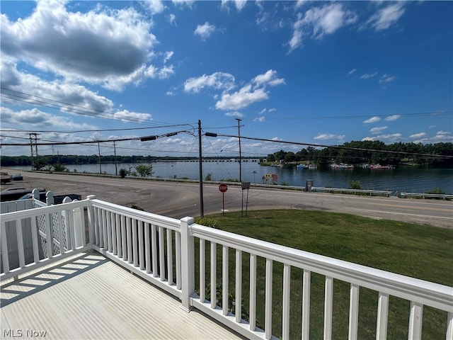 exterior space with a water view and a lawn