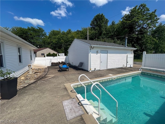 view of swimming pool with a patio and an outdoor structure