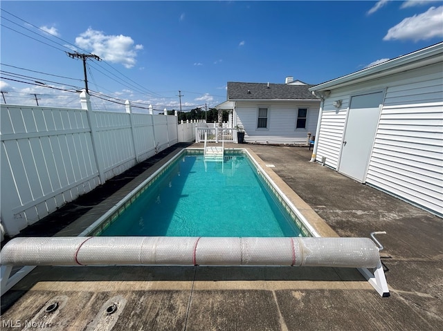 view of swimming pool with a patio area