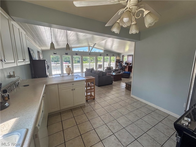 kitchen with ceiling fan, white cabinets, vaulted ceiling with beams, and light tile patterned floors