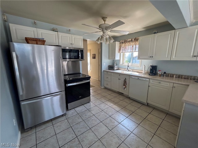 kitchen featuring appliances with stainless steel finishes, light tile patterned flooring, white cabinets, and ceiling fan