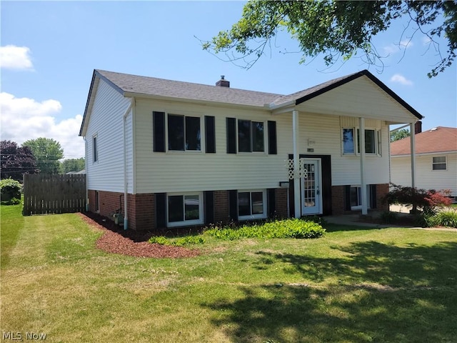 bi-level home with a front lawn