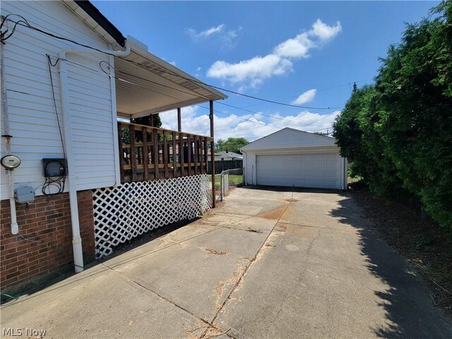 view of side of property featuring a garage and an outbuilding