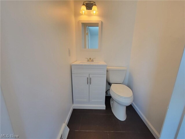 bathroom with tile patterned floors, vanity, and toilet