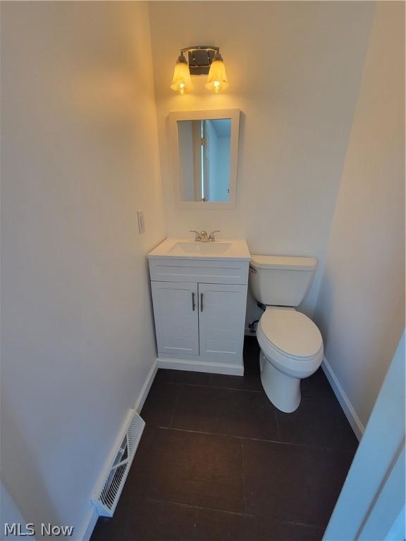 bathroom with tile patterned floors, vanity, and toilet