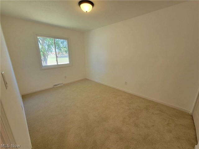 empty room with light colored carpet