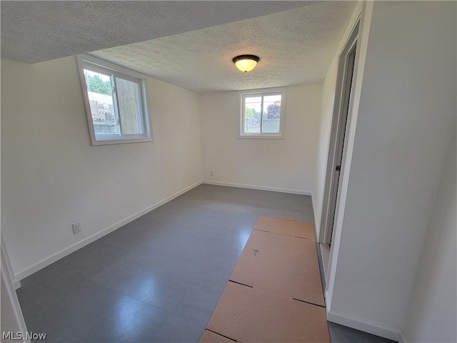 basement featuring a textured ceiling