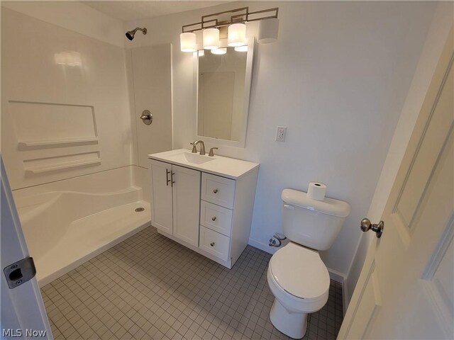 bathroom featuring a shower, vanity, toilet, and tile patterned flooring