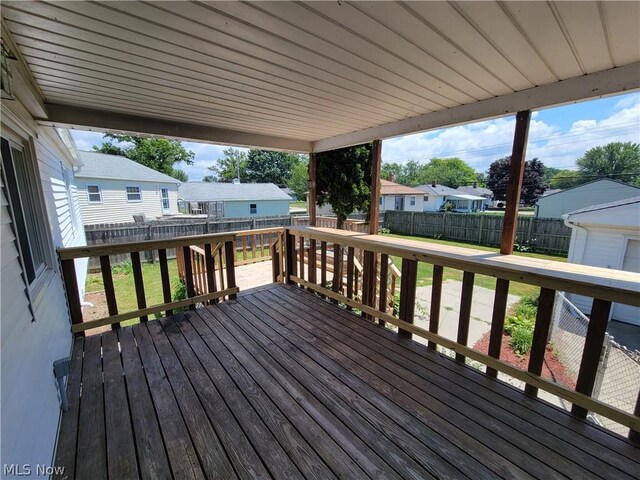 wooden terrace featuring a yard