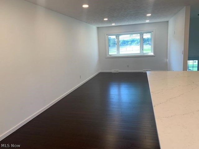 spare room with dark hardwood / wood-style flooring