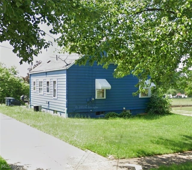 view of side of property with a yard