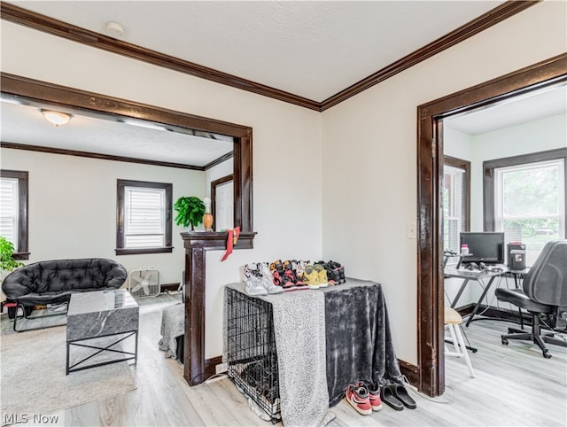 hall with ornamental molding and light hardwood / wood-style flooring